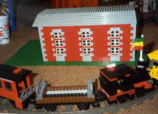 Train passes by engine house that Chris built.