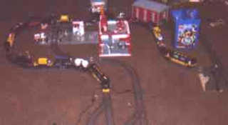 Long train snakes its way among the buildings.